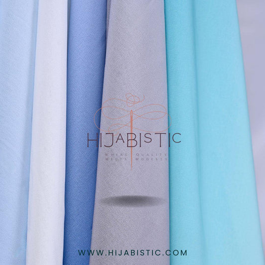 Hijabistic logo with url for website hijabistic.com and multiple colors of hijabs as background