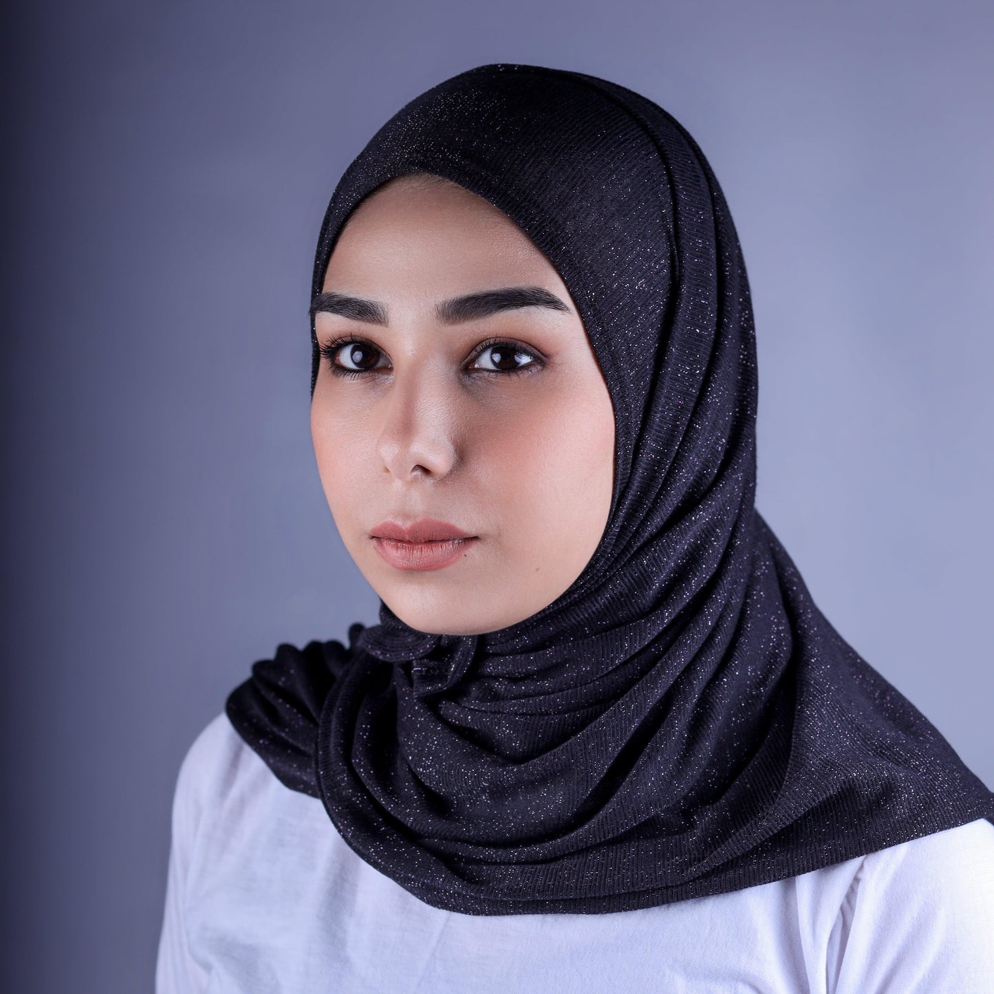 Front view of Hijabistic’s Klara Shawl in Woodsmoke Black - deep black Cotton Lycra Lamé hijab with classic style.